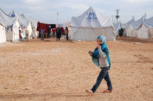 A child walks in a United Nations refugee camp in Turkey where thousands of Syrian refugees reside.