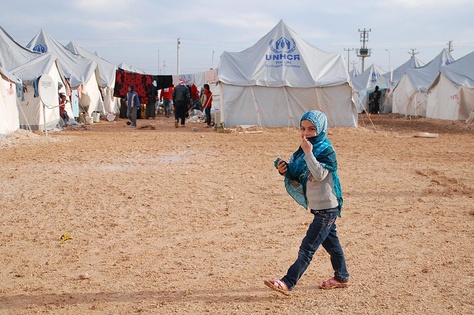 A child walks in a United Nations refugee camp in Turkey where thousands of Syrian refugees reside.