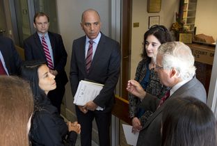 Former Chief Justice of the Texas Supreme Court Wallace Jefferson speaks with a group of people after oral arguments before the Texas Supreme Court. Jefferson argued on behalf of six plaintiffs who were charged with court fees during divorce proceedings even though all six had filed "pauper petitions."