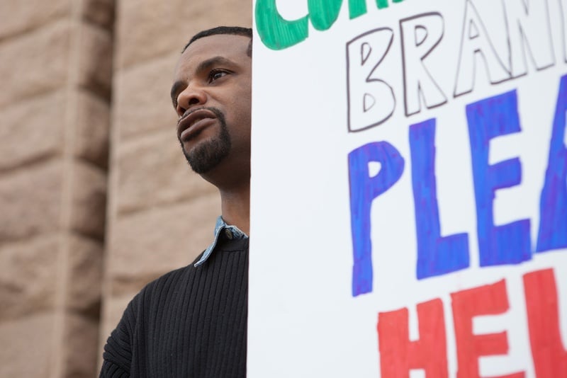 Juan Boston, of Humble, holds a sign in support of injured workers on the steps of the Texas Capitol. The former truck driver has fought a years-long battle for workers' compensation benefits following a back injury that required surgery.