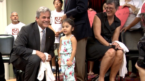 Austin Mayor Steve Adler and Travis County Judge Sarah Eckhardt meet a girl after a rally at the Workers Defense Project in East Austin on Oct. 10, 2015.