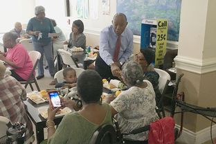 State Rep. Sylvester Turner shakes hands at a Houston retirement center while campaigning for mayor Monday.