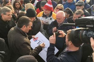 Ted Cruz signs a poster Tuesday after a rally in Hudson, New Hampshire. The Republican presidential candidate returned to the state for the first time in two months.