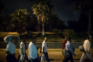A group of undocumented Mexican national ex-offenders enter Mexico at the US-Mexico border crossing at Brownsville/Matamoros after being deported from the United States on Nov. 4, 2015.
