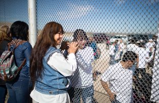 Maria Guadalupe Perez of Juarez holds the hand of her daughter through the border fence in Juarez, Monday, February 15, 2016. Perez has not seen her daughter, Linda Rodriguez, since she was 6 months old.