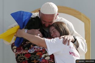 Pope Francis hugs two girls during a meeting with youths at José María Morelos y Pavón stadium in Morelia, Mexico on Feb. 16. 2016.
