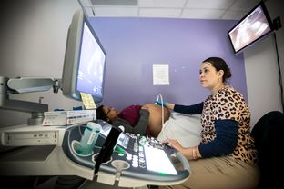 Under a sign warning about Zika virus, Josseline Lopez, 22, gets an ultrasound from technician Ivonne Murillo at Legacy Community Health Clinic in Houston on Feb. 25, 2016.