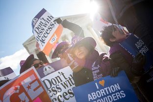 Lara Chelian, center, and her mother, Renee Chelian, both abortion providers from Michigan, hold signs in front of the U.S. Supreme Court in Washington, D.C., as Whole Woman’s Health v. Hellerstedt is argued inside on March 2, 2016. The case is focused on the Texas law known as House Bill 2.