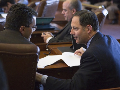 State Rep. Rafael Anchia, D-Dallas, speaks with fellow Rep. Mark Strama, D-Austin, after 2013 committee assignments are announced.