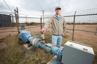 Kyle Krueger, a staff engineer with the Colorado River Municipal Water District, stands next to an older water well on land acquired through state financing near Wickett, Texas.