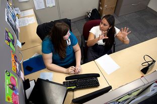 Rachel Bristow, a caseworker for Goodwill's GED program, assists 22-year-old Anita Rodriguez, who received her GED in August 2011, with her financial aid application at the Goodwill Resource Center in Austin, Texas.