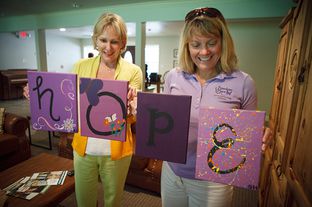 Executive Director Kellie Armstrong, right, and founder Nikki Richnow, left, showing some of paintings that the resident girls made while at Freedom Place near Houston Monday, July 2, 2012.