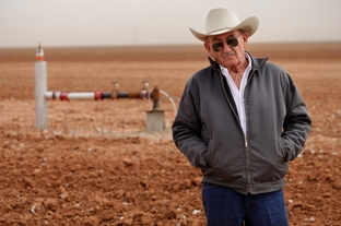 Tommy Fondren in his cotton field near a well pumping station in Lorenzo, TX, on Mar. 8, 2012