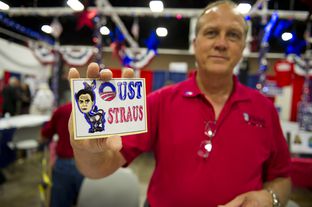 Mike Zapp of Burleson, TX holds an "Oust Straus" sticker at the Tea Party booth at the state Repulblican Convention on June 7, 2012.