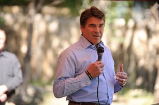 Gov. Rick Perry, speaks at the site in Jonestown, Texas, where volunteers will build a home for injured war veteran Augustine "Augie" Pena.