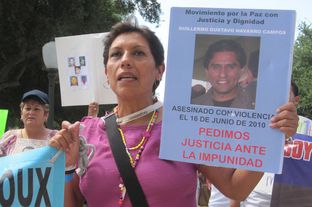 A member of the Caravan for Peace with Justice and Dignity marches on the state Capitol Saturday, August 25, 2012.
