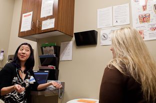 Patient Carrie Adner of Austin speaks with Dr. Krissie Yamamoto at the Seton-Circle of Care Women's Services at the Texas A&M Health Science Center.