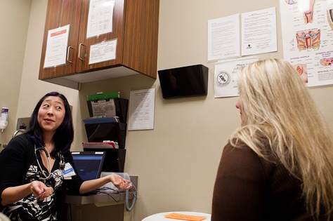 Patient Carrie Adner of Austin speaks with Dr. Krissie Yamamoto at the Seton-Circle of Care Women's Services at the Texas A&M Health Science Center.