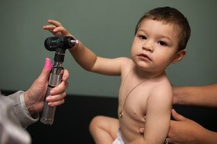 Helen Hawkins, a certified pediatric nurse practitioner, treats 13-month-old Kevin Gorostieta at Carousel Pediatrics in Austin on Nov. 8, 2012.