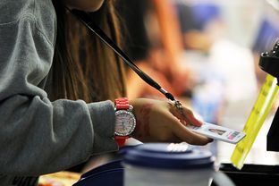 Students scan their radio frequency identification tags as they pass through the lunch line at Jones Middle School in San Antonio, September 14, 2012.