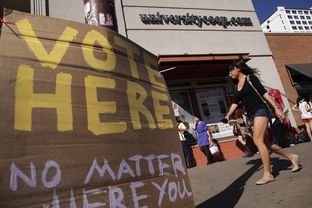 Voters wait in line to cast their ballots at a location across the street from the University of Texas at Austin campus on Tuesday, Nov. 6, 2012.