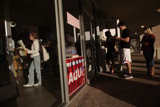 Voters wait in line to cast their ballots at a polling station in the Hancock Center on Tuesday Nov. 6, 2012 in Austin, Texas.