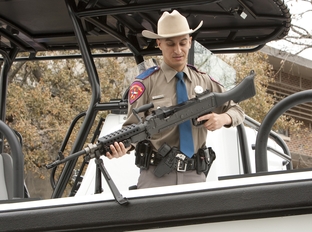Texas DPS agent Cuevas removes a M2-40 machine gun from newly commissioned patrol vessel. The boat, part of the Tactical Marine Unit, funded by federal Homeland Security grants, will help with the state's efforts in combating Mexican drug cartels patrolling the Rio Grande River