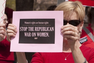 Woman at Texas Capitol protests Republican lawmakers decision to exclude Planned Parenthood from the Women's Health Program