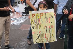 A young Mexican child at a YoSoy132 protest in Mexico City's Plaza de Las Tres Culturas. The sign pleads for voters to think of the child's generation when casting their ballots.