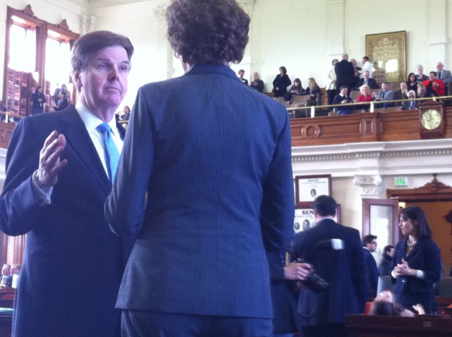 Dan Patrick talks with comp Susan combs in senate chambers.
