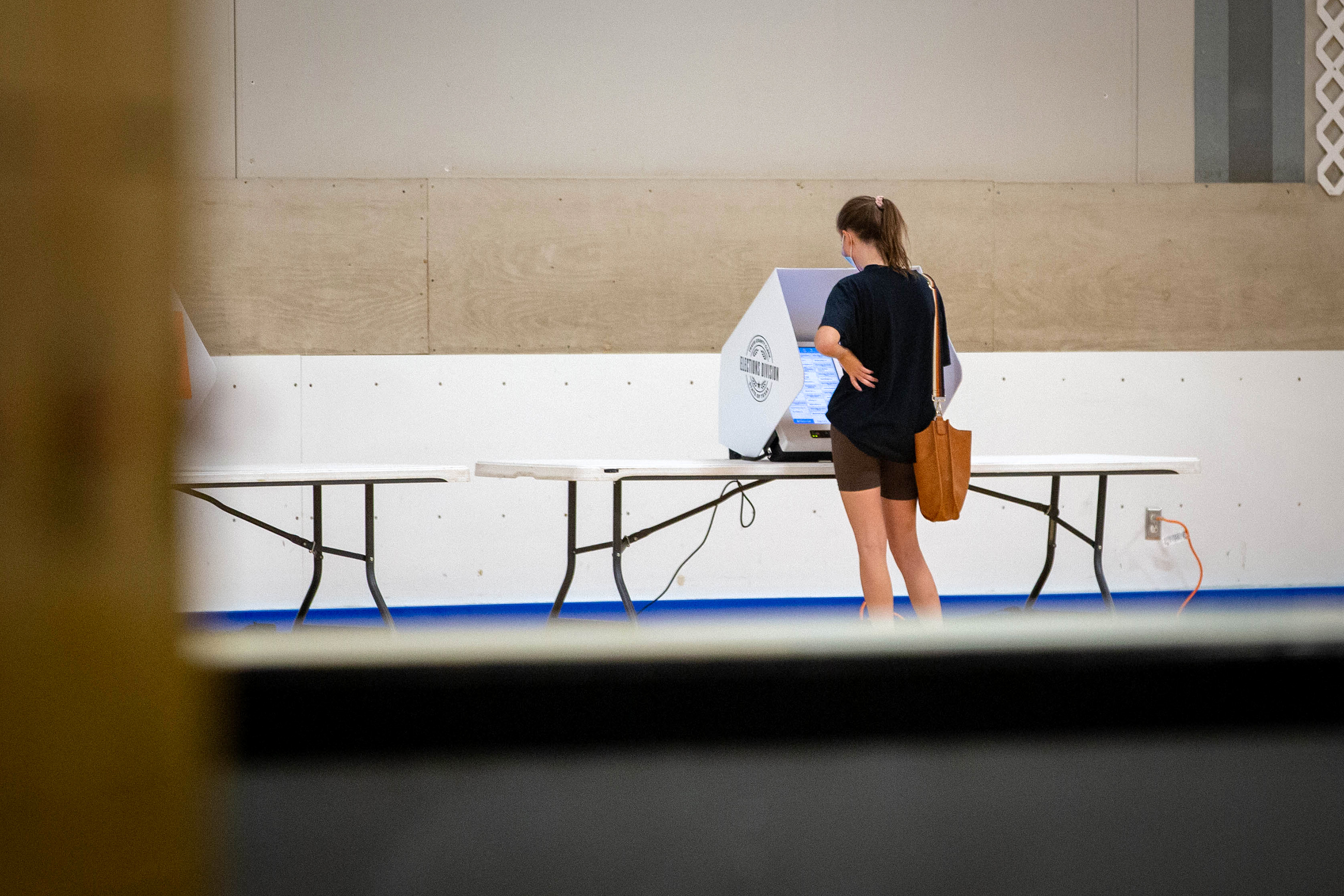 A voter casts their ballot at the Parque Zaragoza Recreation Center in Austin on the first day of early voting on Oct. 13, 2020. Voters are able to cast their ballots early until Oct. 30, 2020.