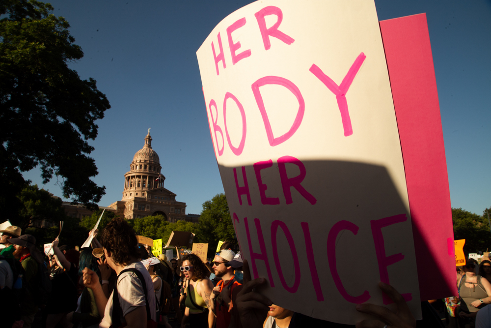 A crowd marches past the Texas Capitol during a protest against Friday’s ruling by the U.S. Supreme Court that there’s no constitutional right to abortion. (Evan L’Roy/The Texas Tribune)