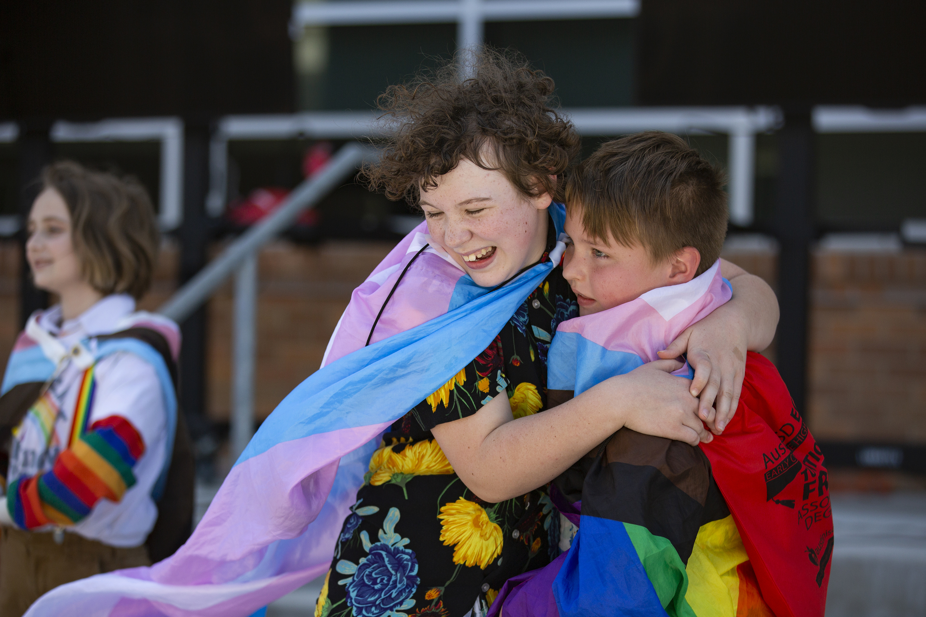 Rae Fenton, 12, hugs brother Eli, 7, as he joins him on the stage during Diamond Dior Davenport's performance. "I love drag …