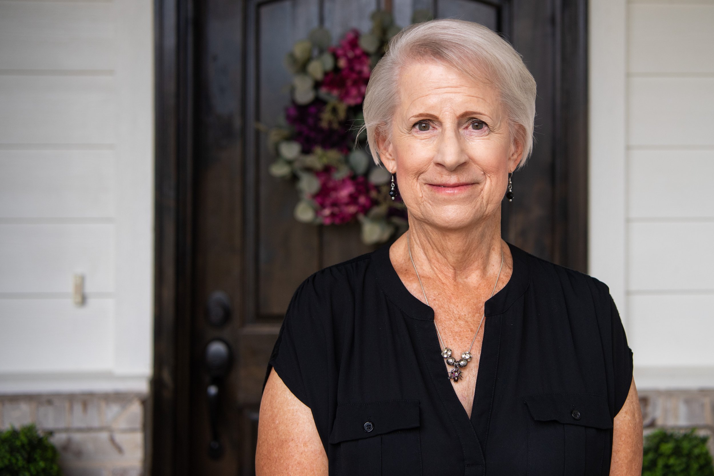 Joanne Kropp poses for a photo infront of her home in Bryan, Texas.”