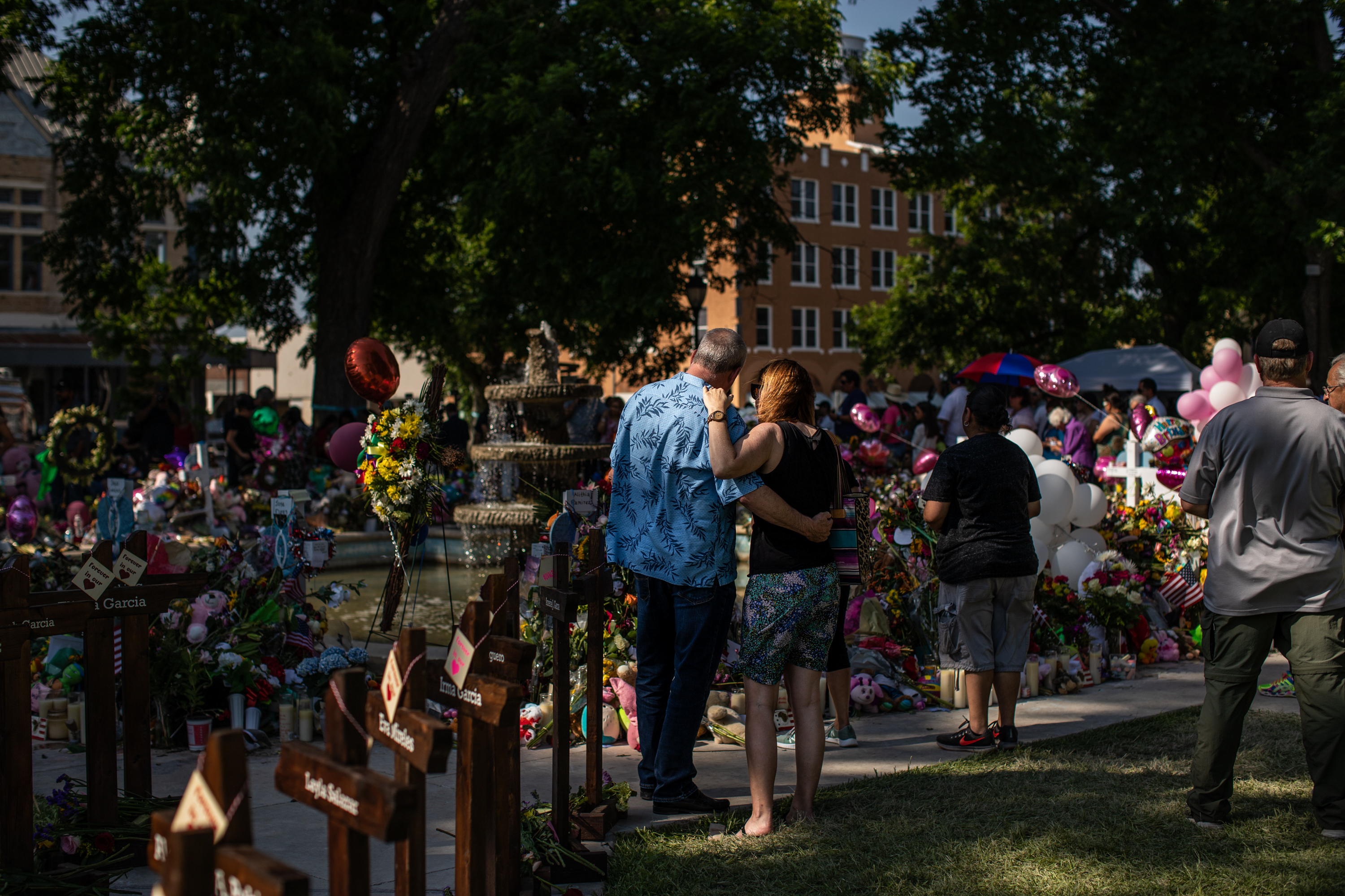 Thousands of roses, handwritten notes, hundreds of candles and dozens of stuffed animals surround a fountain in the center of the City of Uvalde Town Square on May 29, 2022.