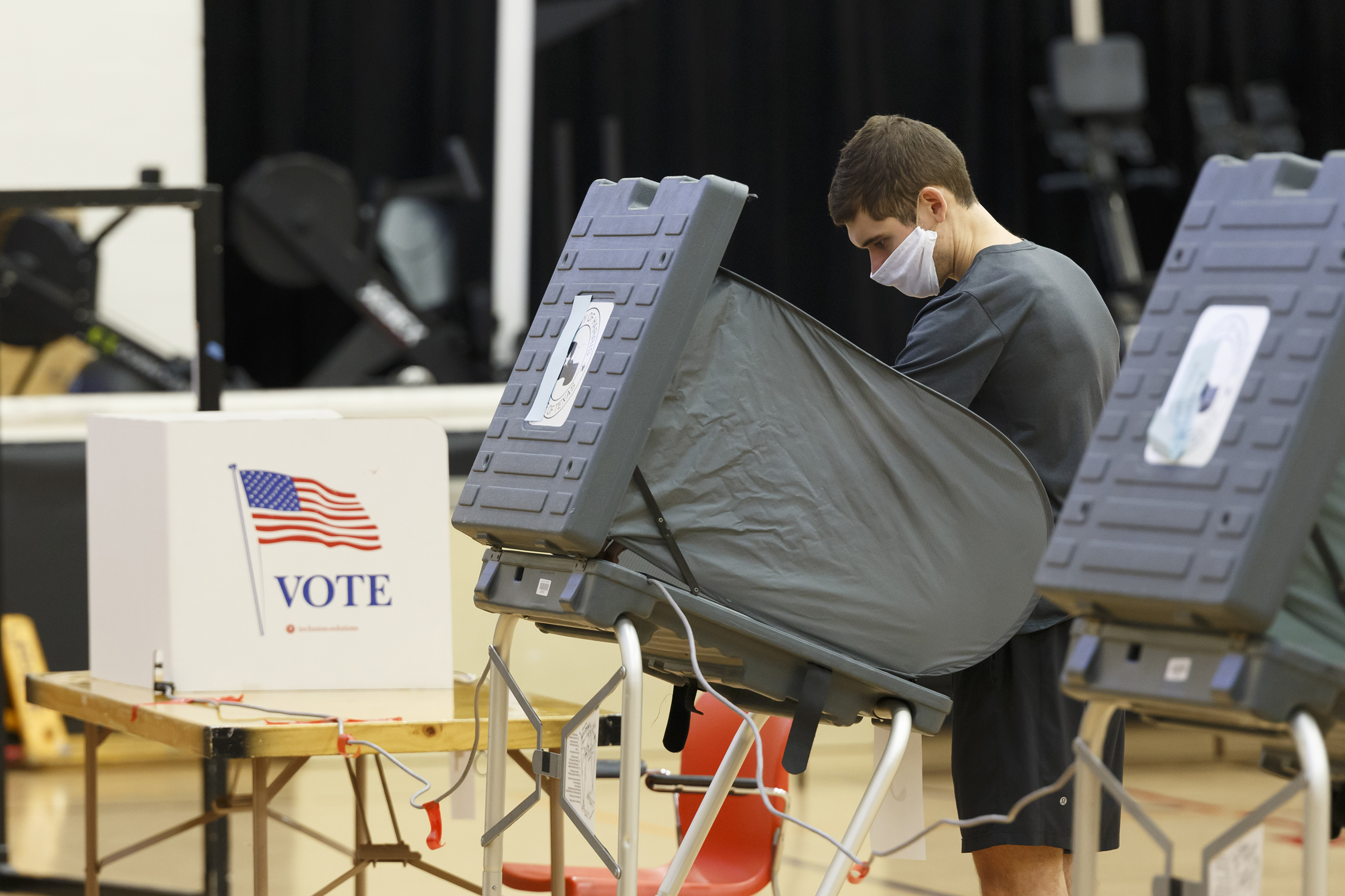 A voter casts a ballot at the Metropolitan Multiservices Center for the delayed primary runoff election in Houston. July 14, 2020. 