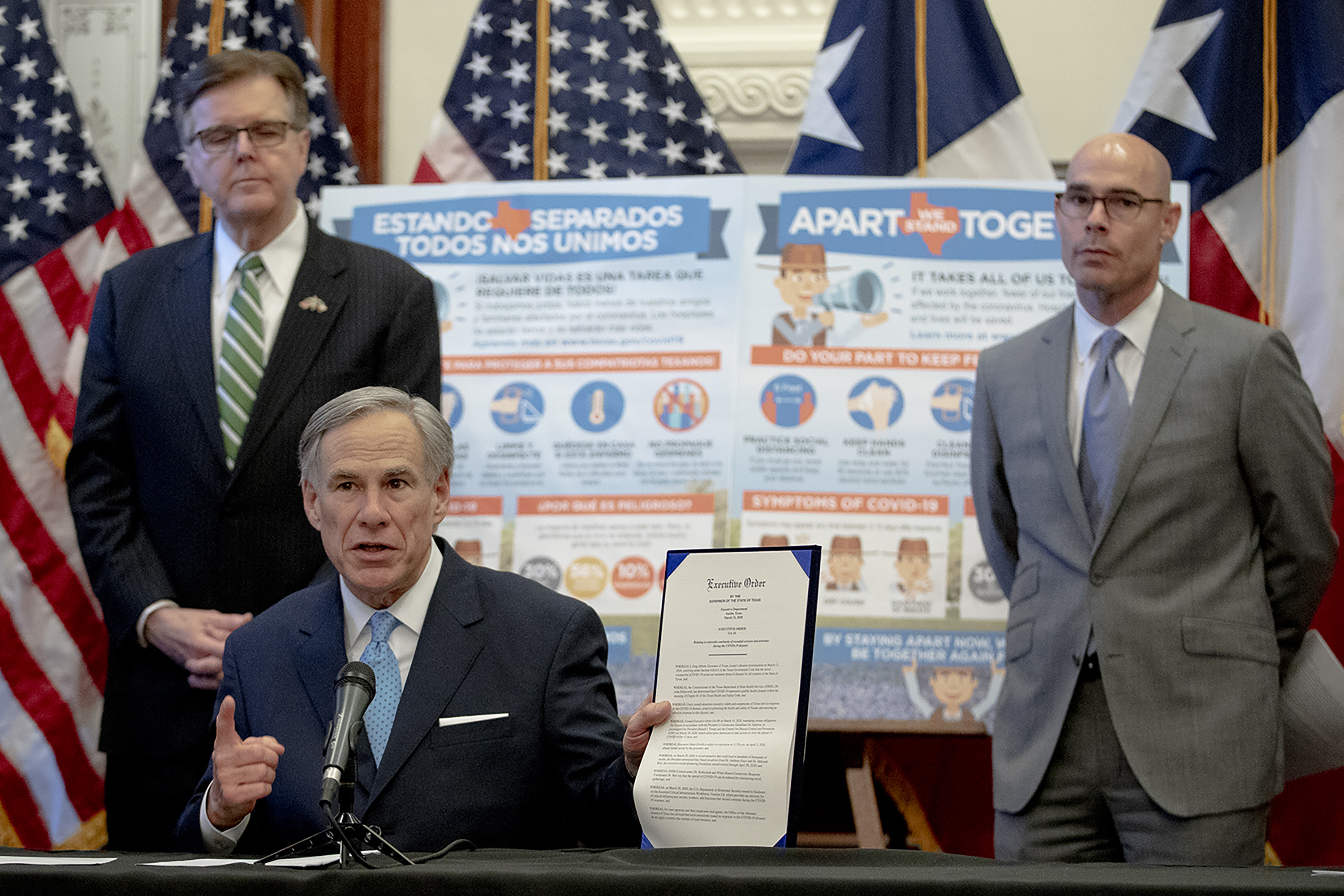 Gov. Greg Abbott, flanked by Lt. Gov. Dan Patrick, left, and House Speaker Dennis Bonnen, speaks during a press conference at the state Capitol over the state's response to the coronavirus on March 31, 2020.