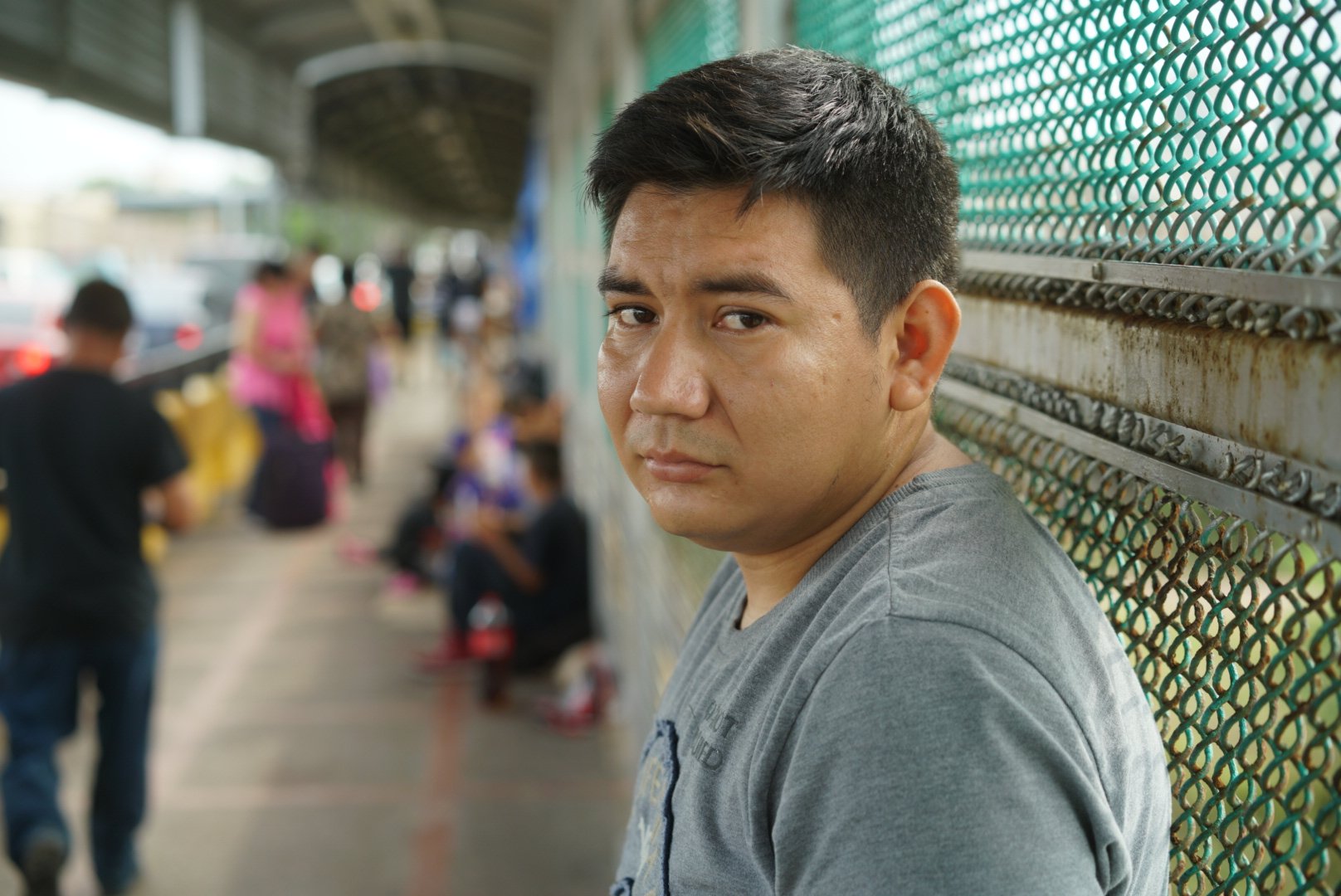 Marcos Samayoa, who traveled from Guatemala to the U.S-Mexico border, waits on the international bridge to seek asylum in the United States