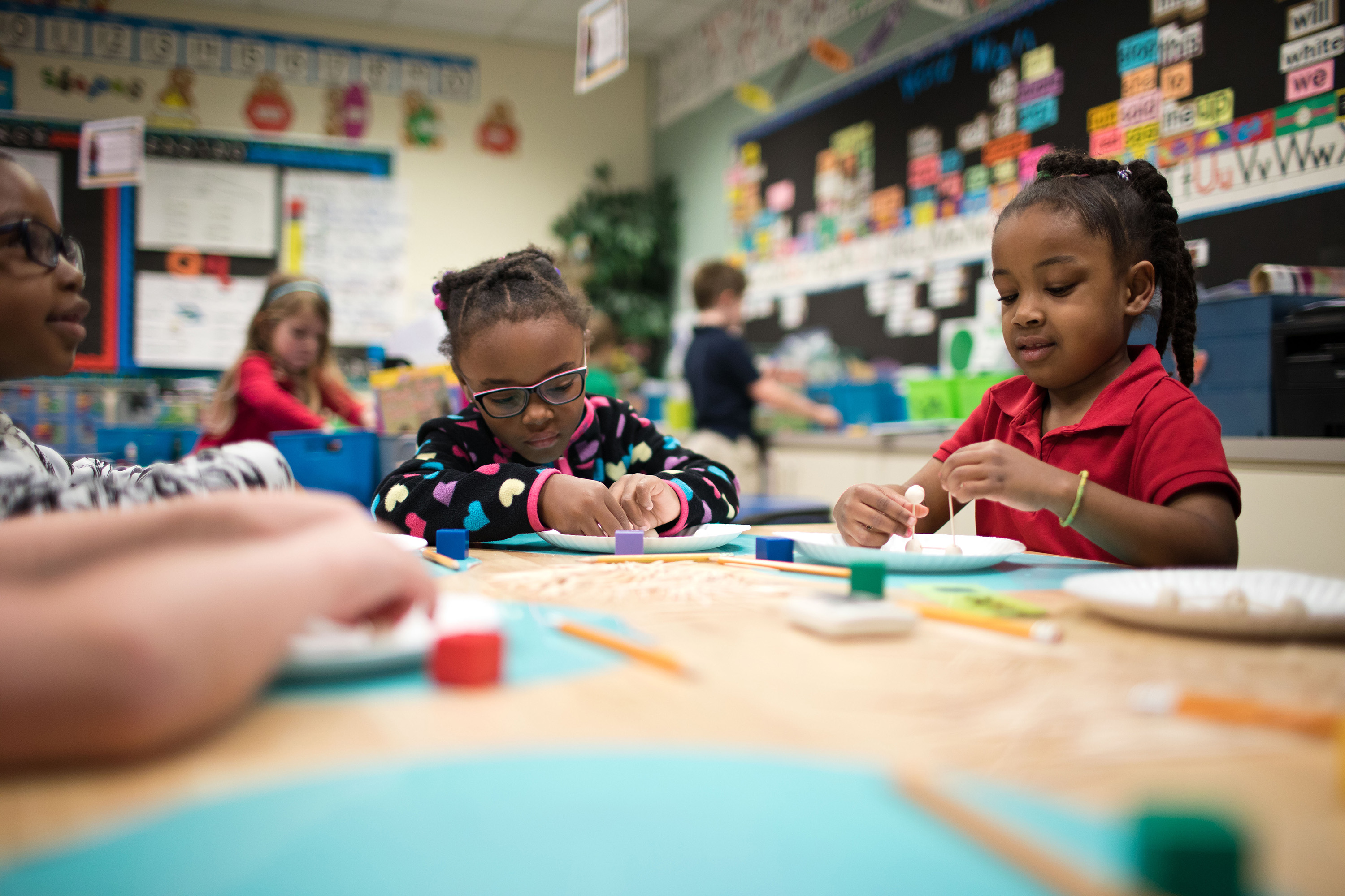 Tatum Roberts (left) and Olivia Mah work on their toothpick cubes in Melanie Martin's kindergarten class at Johnston-McQueen Elementary.