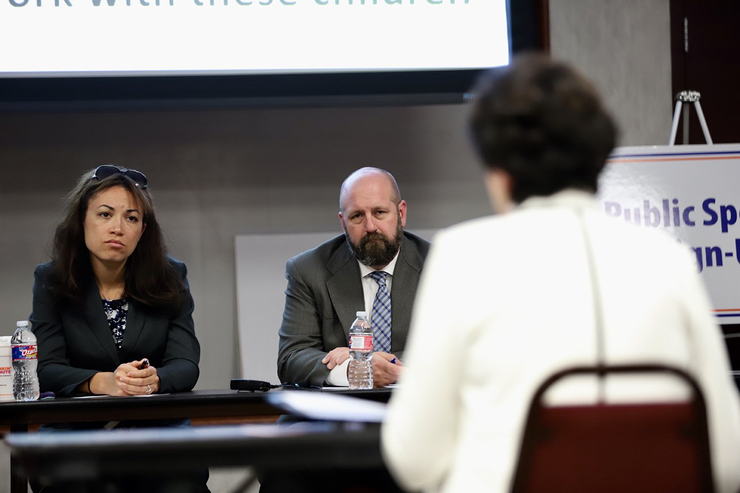 Texas Education officials Penny Schwinn and Justin Porter listen to testimony at a hearing on special education in Richardson on April 16, 2018.