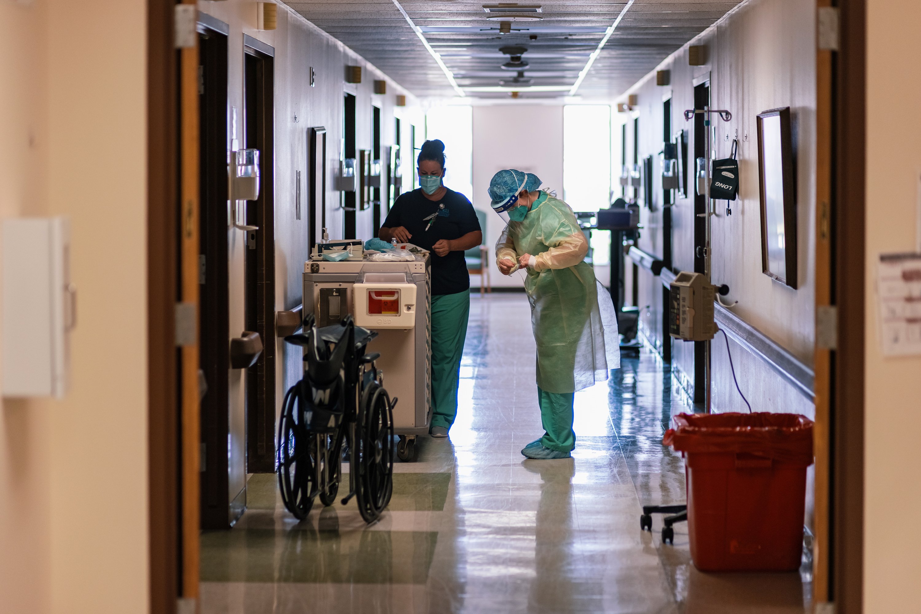 A nurse dons full PPE before entering the room of a COVID-19 patient at Goodall-Witcher Hospital in Clifton on Wednesday, August 3, 2021.