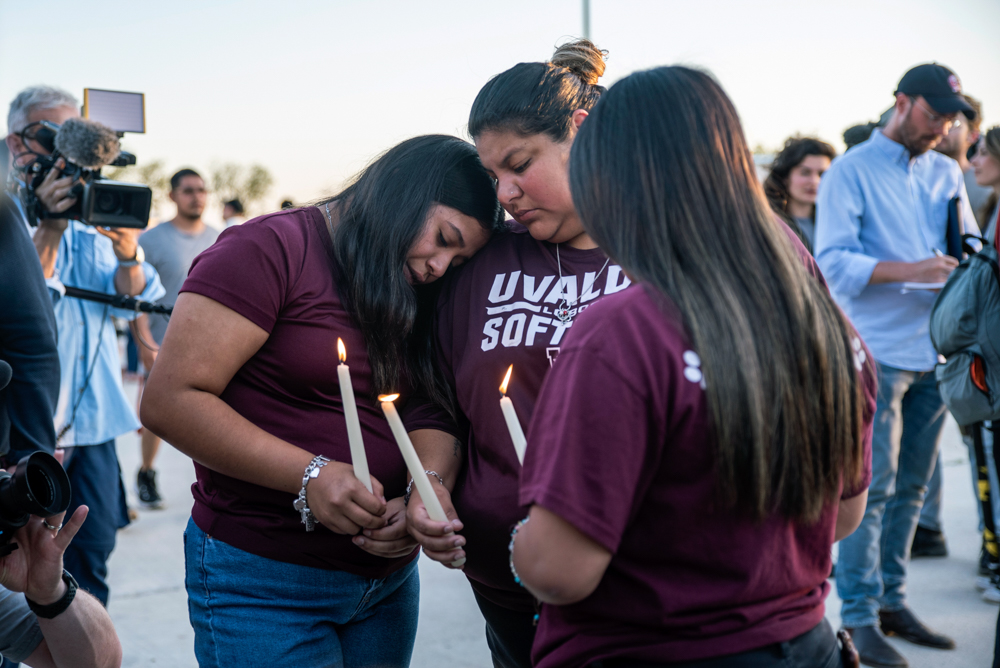Community members console each other during a vigil at the Uvalde County Fairplex on Wednesday. (Sergio Flores for The Texas Tribune)