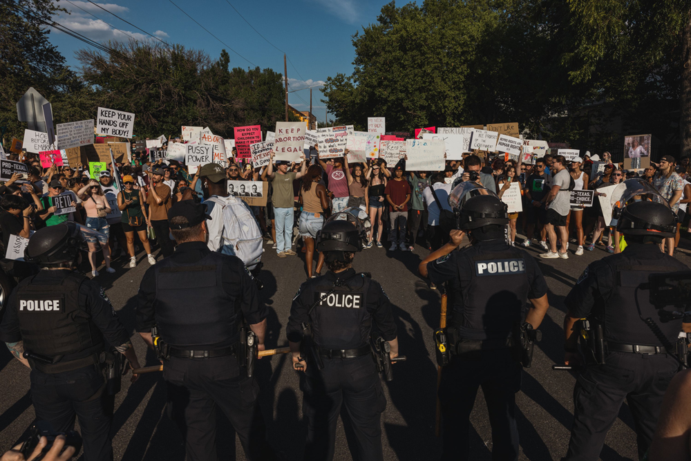 Police formed a line to prevent protesters from walking down Third Street at a rally for abortion rights in Austin on Sunday. (Jordan Vonderhaar for The Texas Tribune)
