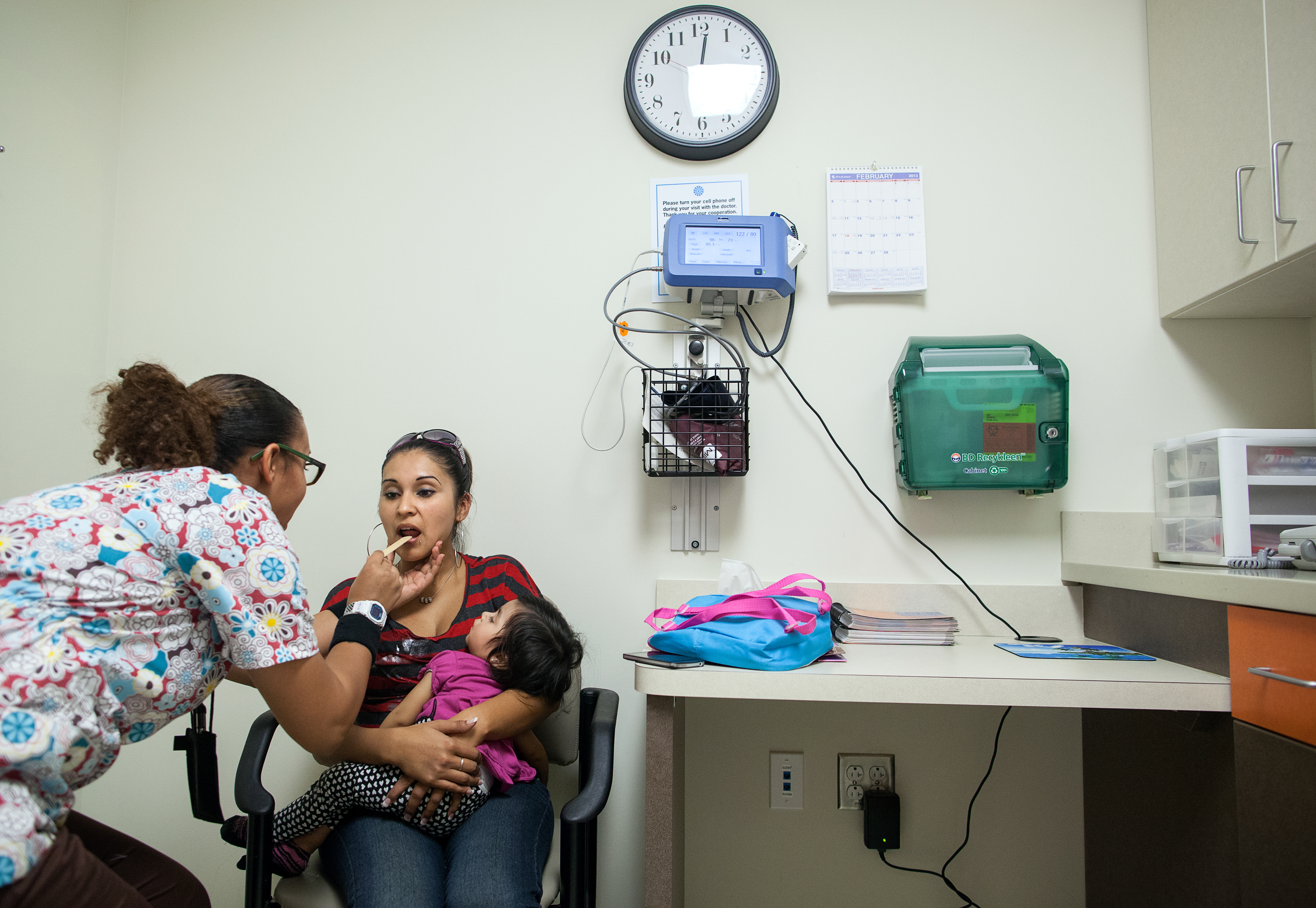 Medical assistant Alesia Bolden checks Nereyda Penaloza'<a href=