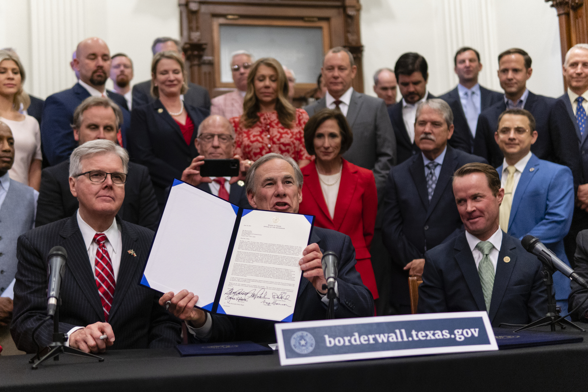 Flanked by Lt. Gov. Dan Patrick and House Speaker Dade Phelan, Gov. Greg Abbott held a press conference at the Capitol on June 16, 2021 to provide more details on his plan for Texas to build its own border wall.