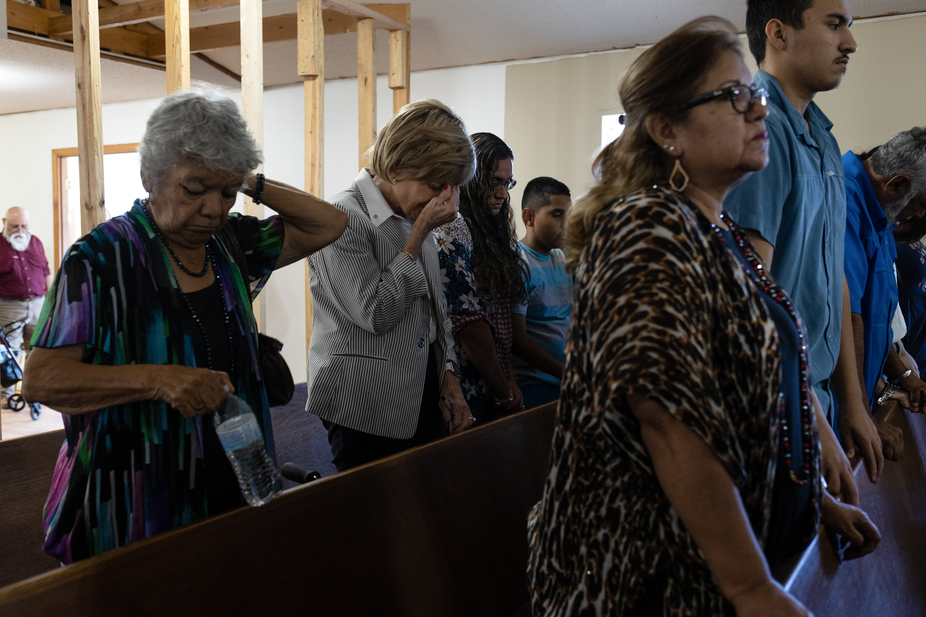 A woman holds her head during mass at Primera Iglesia Bautista Church in Uvalde on May 29, 2022.
