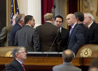House members huddle at dais on February 14th, 2013