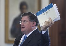 Senate Finance Chairman Tommy Williams, R-The Woodlands, holds a copy of the state budget on the Senate floor March 20, 2013.