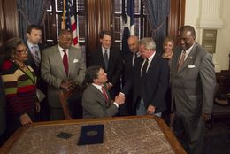 Gov. Rick Perry ceremonially signs Senate Bill 1611, known as the Michael Morton Act, which requires prosecutors to disclose evidence in criminal cases. Morton served nearly 25 years in prison for his wife's murder before he was exonerated in 2011.