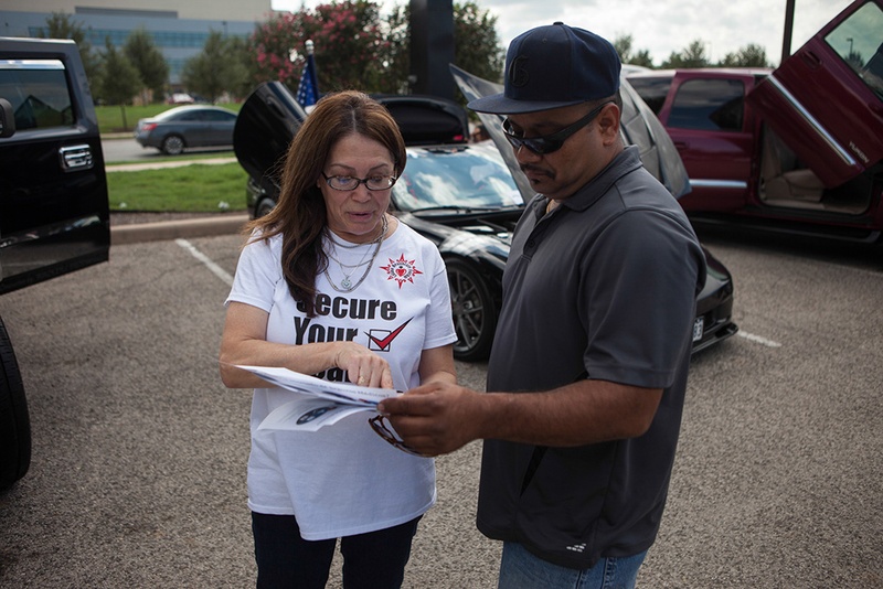 Jill Ramirez, the director of outreach for the Latino Healthcare Forum, passes out flyers and explains components of the Affordable Care Act on Oct. 5, 2013.